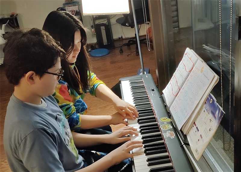 lifia with boy piano lesson.jpg