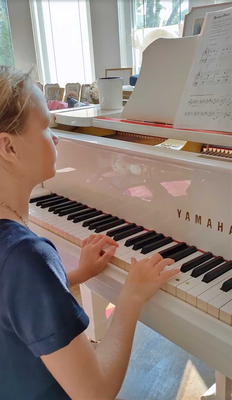 girl piano lesson white piano.jpg