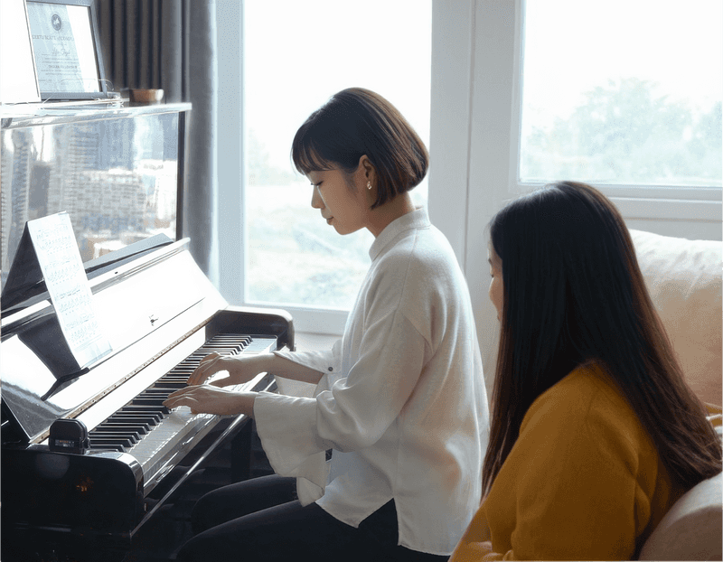 a female piano teaching a female audlt student in the living room.png